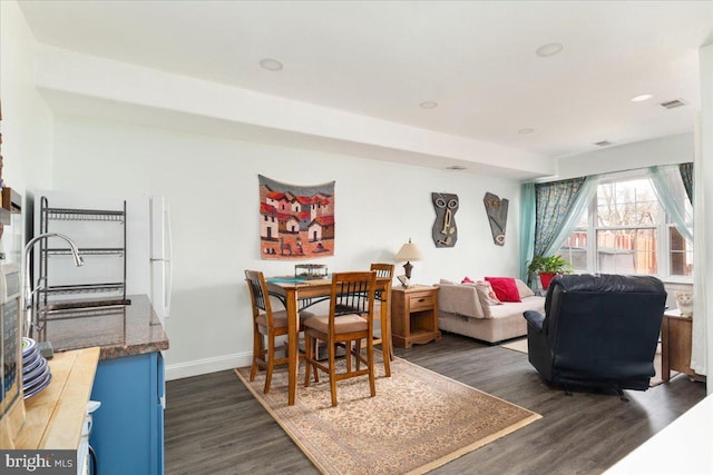 dining room with recessed lighting, visible vents, baseboards, and dark wood-type flooring