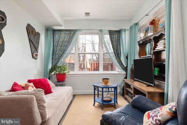 living area featuring visible vents and baseboards