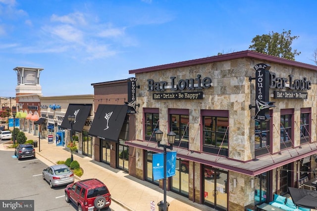 view of building exterior featuring uncovered parking