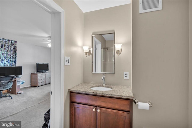 bathroom with visible vents, vanity, and a ceiling fan