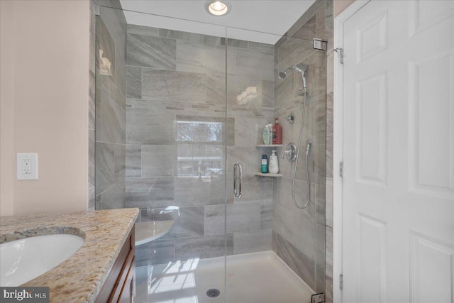 full bath featuring vanity and a shower stall