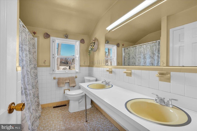 bathroom with a sink, visible vents, toilet, and tile patterned floors