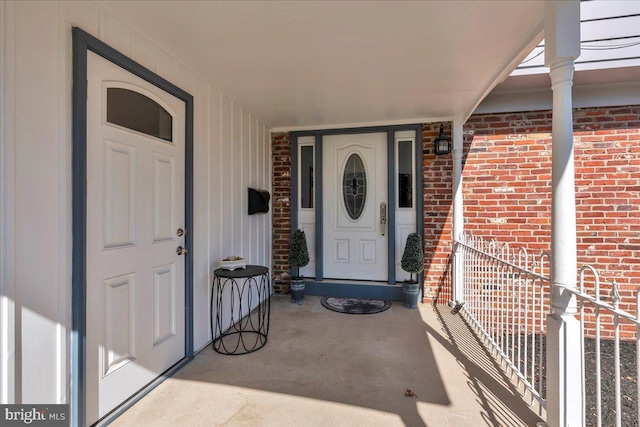 entrance to property featuring brick siding