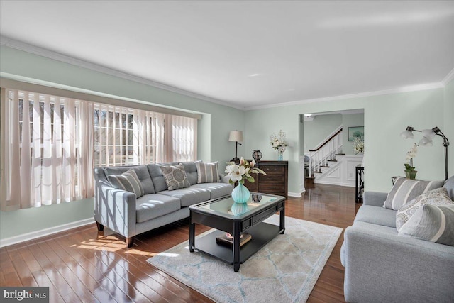 living area with baseboards, dark wood-style floors, stairs, and ornamental molding