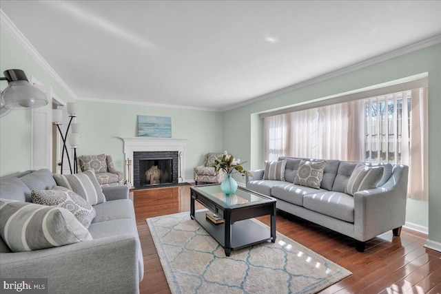 living room with dark wood finished floors, a fireplace with flush hearth, crown molding, and baseboards