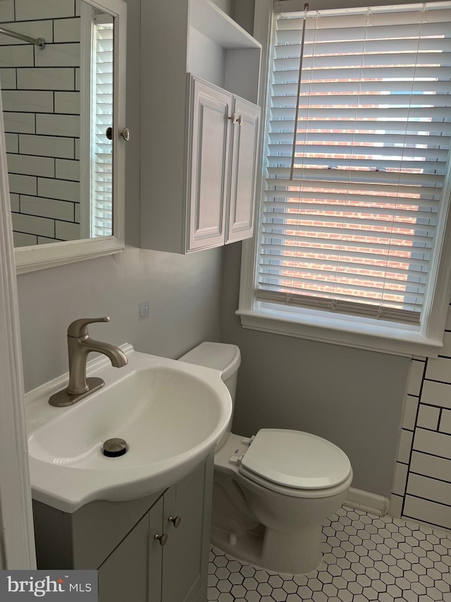 bathroom featuring vanity, tile patterned floors, and toilet