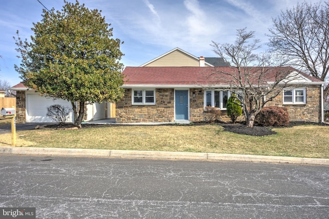 ranch-style house featuring stone siding, a garage, a front lawn, and roof with shingles