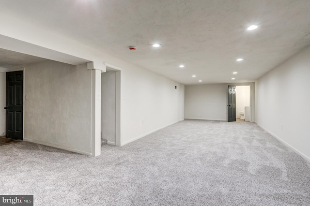 finished basement with recessed lighting, baseboards, and light carpet