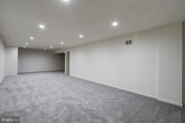 finished below grade area with visible vents, recessed lighting, baseboards, and carpet