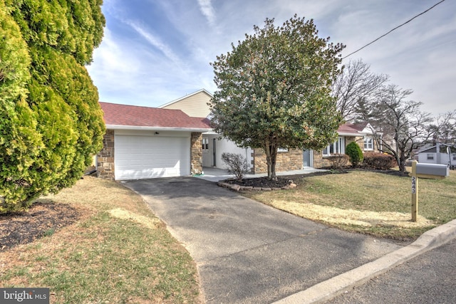 view of front of house featuring a garage, stone siding, a front lawn, and aphalt driveway