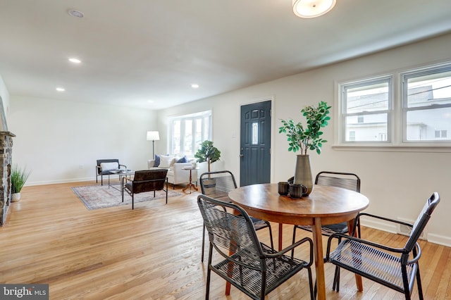 dining room featuring recessed lighting, baseboards, and light wood finished floors