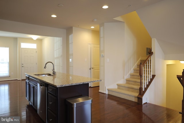 kitchen with dark wood finished floors, recessed lighting, stainless steel dishwasher, and a sink