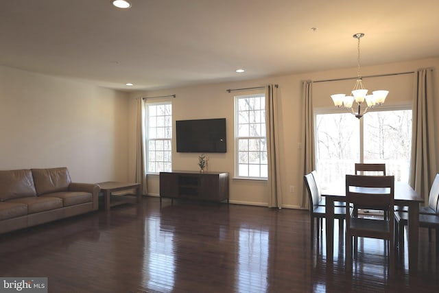 dining area featuring recessed lighting, baseboards, an inviting chandelier, and hardwood / wood-style floors