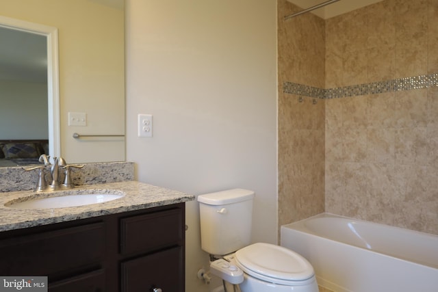 bathroom featuring toilet, vanity, and  shower combination