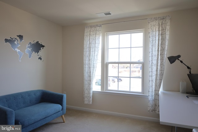 sitting room with visible vents, baseboards, and carpet