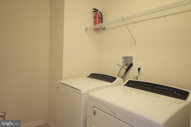 laundry room featuring laundry area, independent washer and dryer, and baseboards