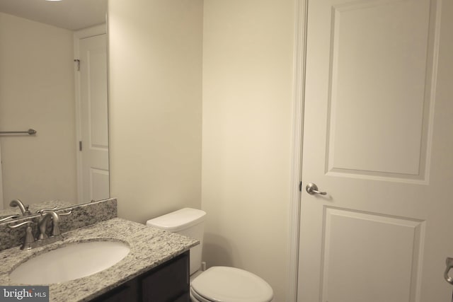 bathroom with toilet and vanity