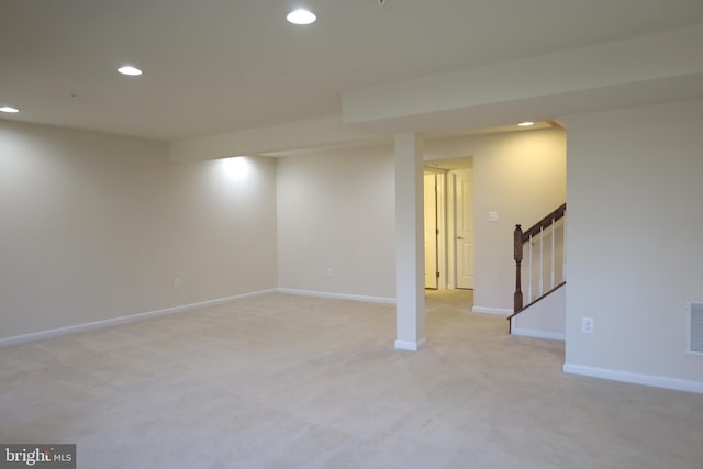 finished basement with stairway, recessed lighting, visible vents, and baseboards