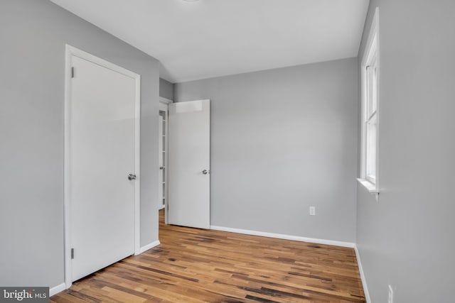 unfurnished bedroom featuring baseboards and wood finished floors