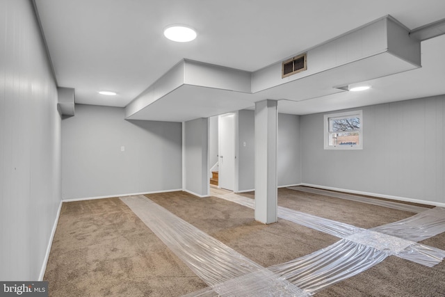 basement featuring stairway, baseboards, and carpet floors