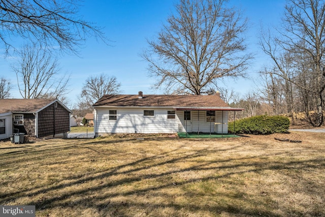 back of house with a yard