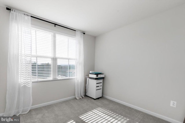 empty room with light colored carpet and baseboards