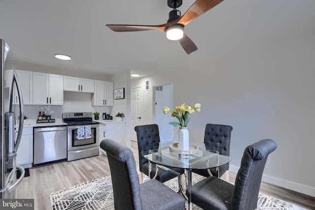 dining room with visible vents, baseboards, light wood-style floors, and ceiling fan