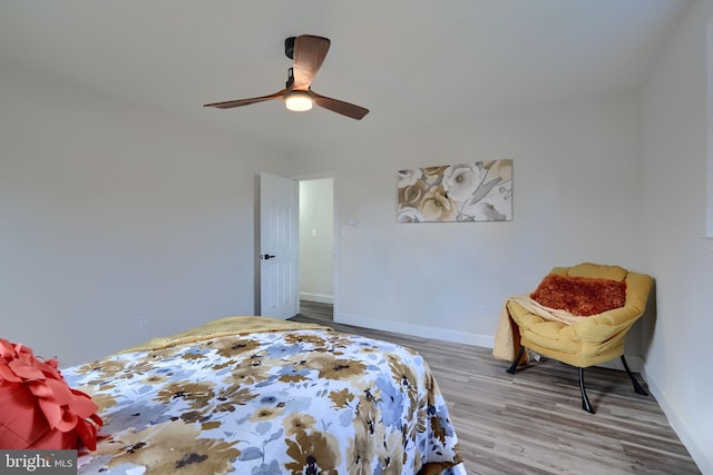 bedroom featuring a ceiling fan, wood finished floors, and baseboards