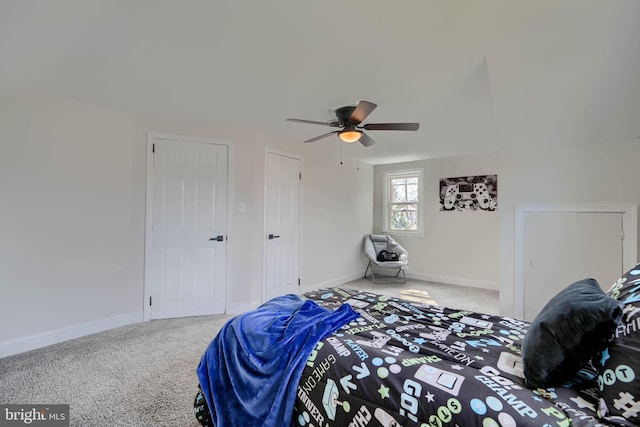 carpeted bedroom featuring baseboards and ceiling fan