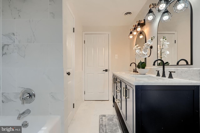 full bath featuring double vanity, shower / washtub combination, marble finish floor, and a sink