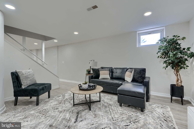 living area featuring recessed lighting, visible vents, and wood finished floors