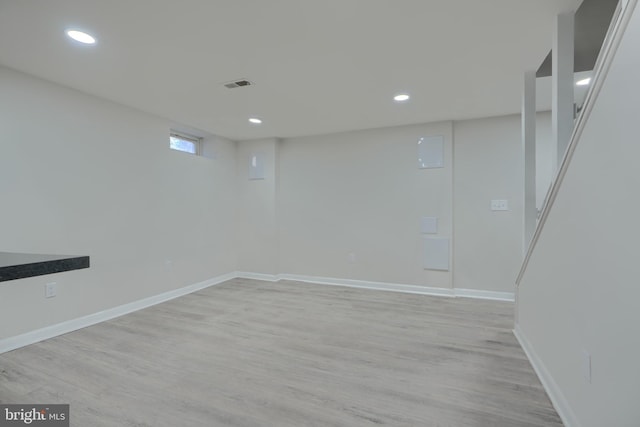 basement featuring recessed lighting, visible vents, baseboards, and light wood-style floors