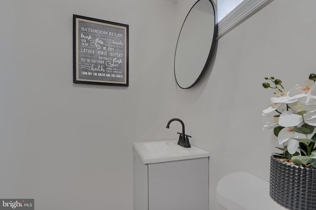 bathroom with toilet and vanity