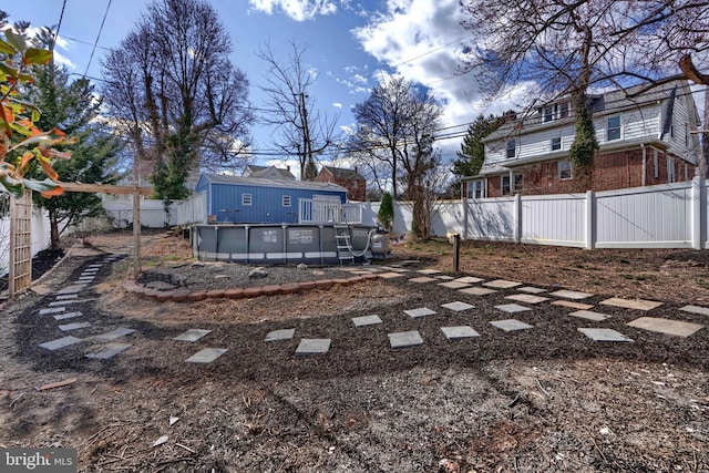 view of yard featuring a fenced in pool, a residential view, and a fenced backyard