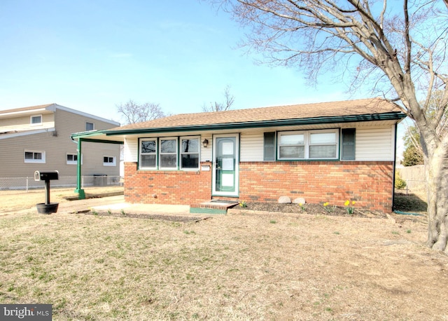 single story home with brick siding, a shingled roof, a front lawn, fence, and cooling unit