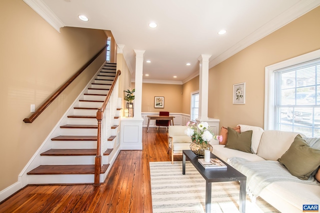 living room featuring ornamental molding, recessed lighting, stairway, wood-type flooring, and decorative columns