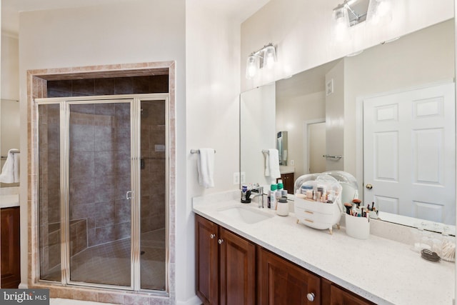 bathroom featuring a stall shower and vanity