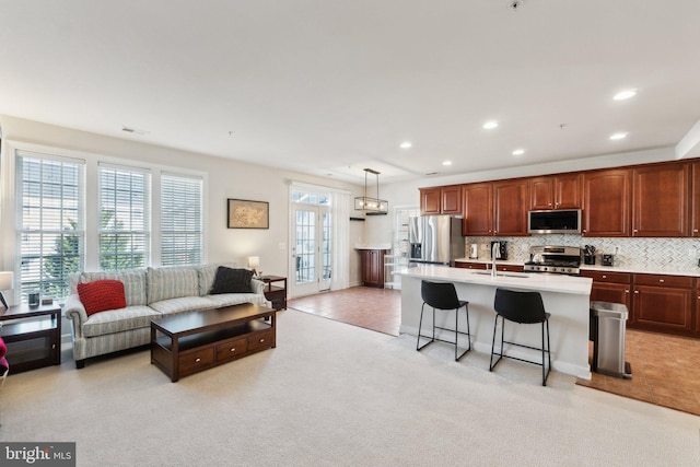 living room featuring light carpet, visible vents, recessed lighting, and light tile patterned floors