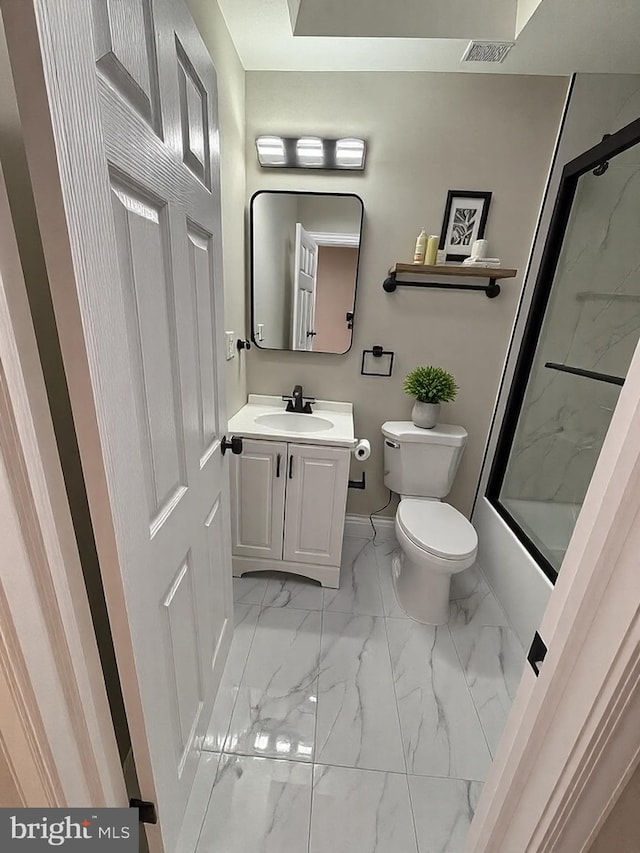 bathroom featuring visible vents, toilet, marble finish floor, combined bath / shower with glass door, and vanity