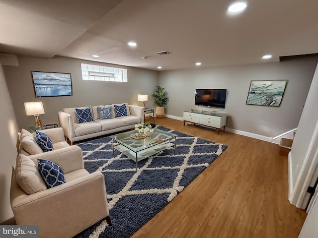 living room featuring recessed lighting, wood finished floors, visible vents, and baseboards