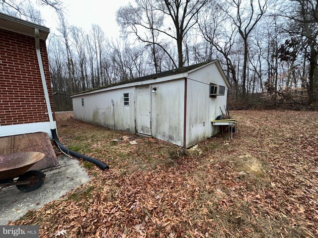 view of outbuilding featuring an outdoor structure and a wall unit AC