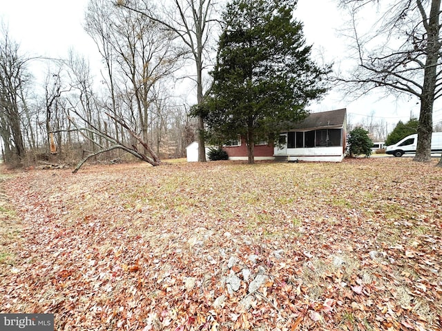 view of yard with a sunroom