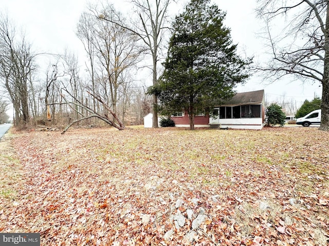 view of yard featuring a sunroom