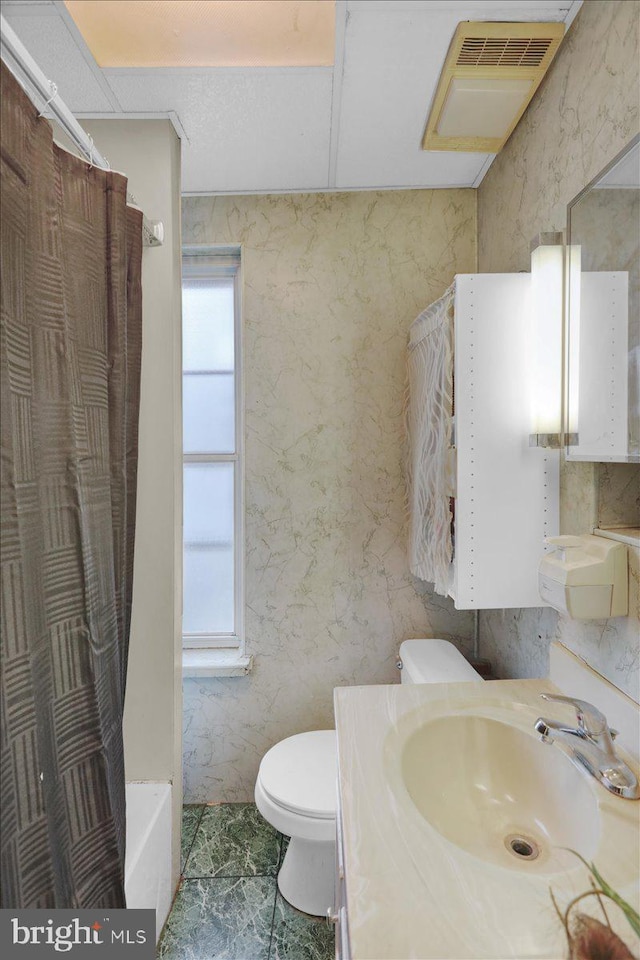 full bath with a wealth of natural light, toilet, vanity, and wallpapered walls