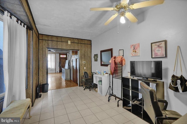 tiled office with wooden walls and a ceiling fan