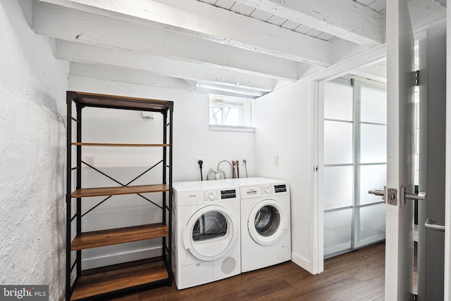 clothes washing area featuring dark wood-style floors, laundry area, and washing machine and dryer