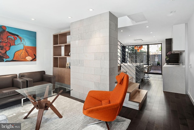 living room with dark wood finished floors, a wall of windows, stairway, and recessed lighting