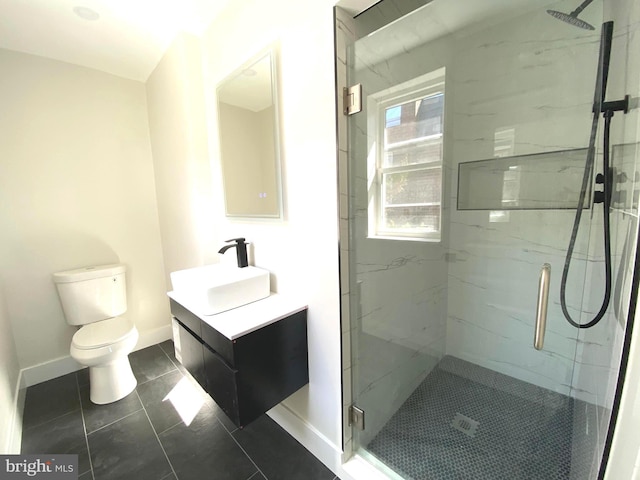 full bathroom with a marble finish shower, baseboards, toilet, and vanity