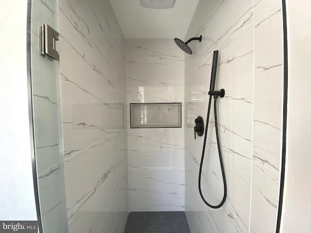 full bathroom with a marble finish shower