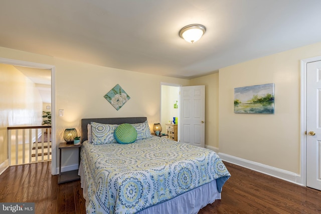 bedroom featuring baseboards and wood finished floors